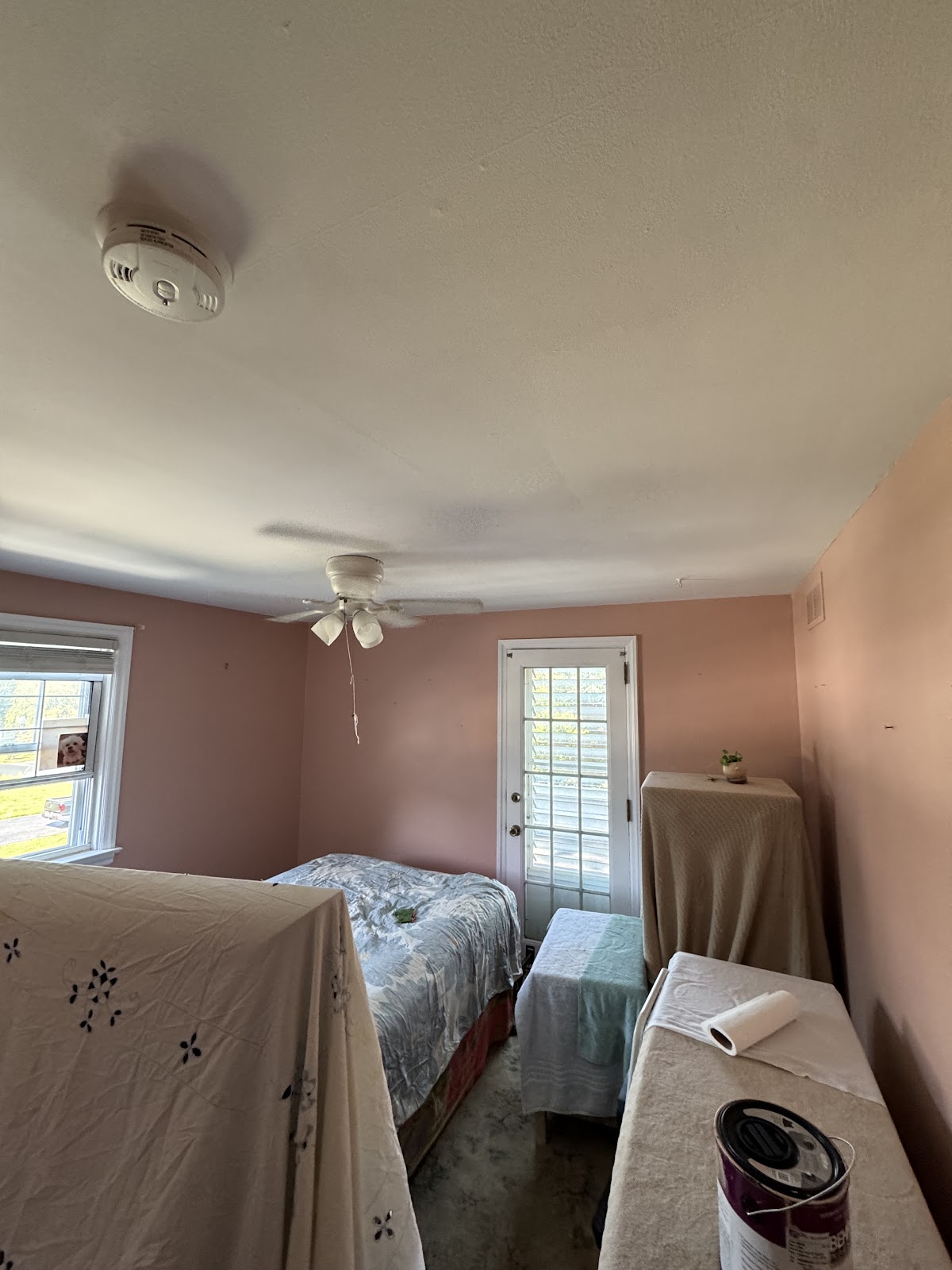 Bedroom mid repaint with furniture protected under drop cloths