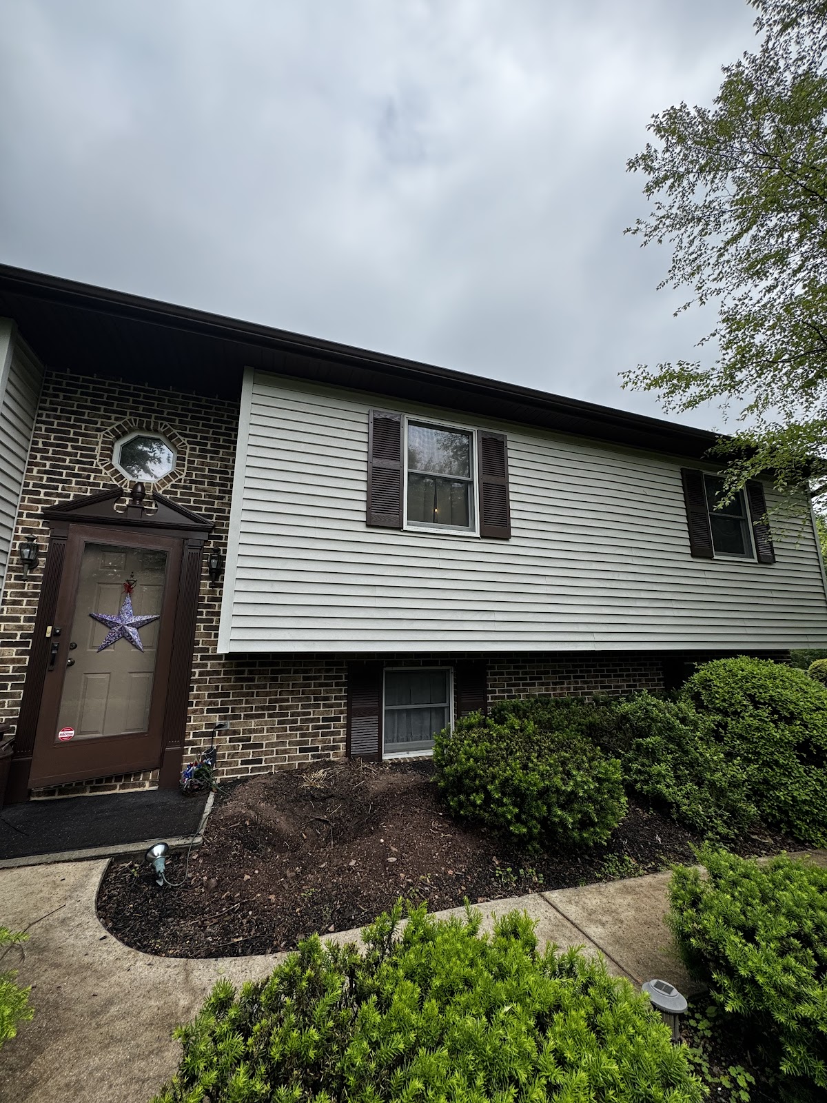 House exterior with freshly painted pale sage siding